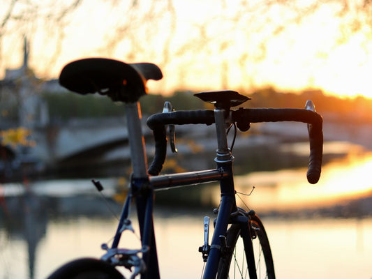 Ciclista en una carretera despejada al amanecer, listo para un largo recorrido con equipo completo en su bicicleta.