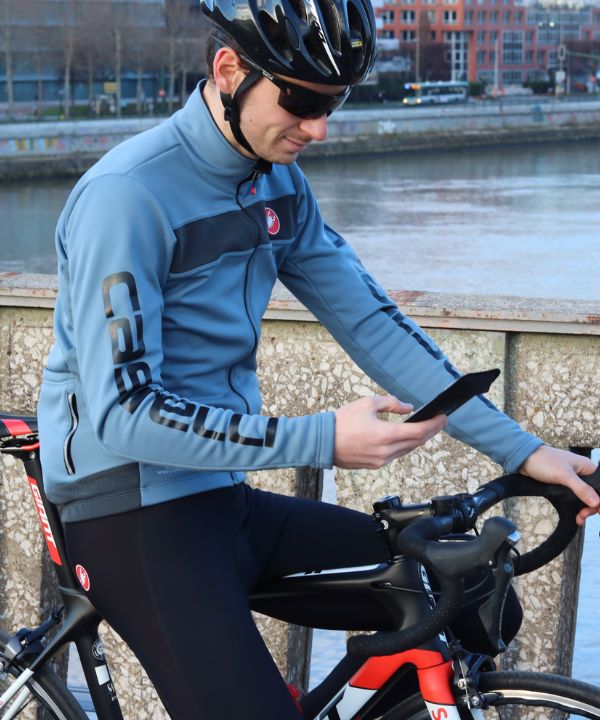 Ciclista con teléfono fijado al manillar mediante soporte Shapeheart.